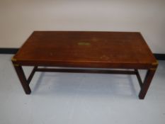 A mahogany campaign style coffee table with brass mounts