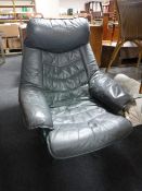 A twentieth century green leather swivel armchair
