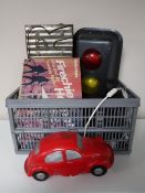 A box containing an electric traffic light, VW Beetle lamp, boxed fire helmet,