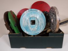 A box containing contemporary wooden ornaments, wooden wall masks, hockey sticks, croquet mallets,