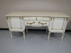 A white and gilt inverted break-front pedestal sideboard