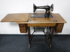 A Singer Treadle sewing machine in an oak table