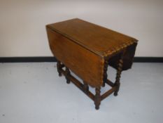 An oak barley twist gate leg table