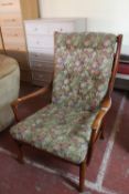 A late twentieth century Parker Knoll teak armchair upholstered in a floral button fabric