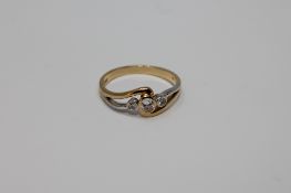 An 18ct gold three stone diamond ring