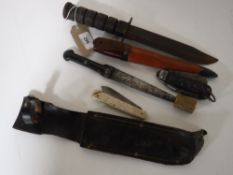 A hunting knife in leather sheath, a K.