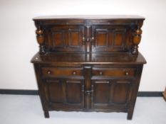 An Ercol court cupboard and an oak corner cabinet