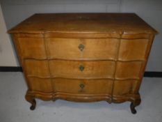 A 19th century oak serpentine fronted three drawer chest