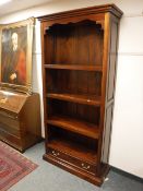 A Barker and Stonehouse bookcase, fitted with a drawer,