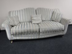A contemporary scroll arm settee,