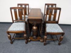 An oak drop leaf table on carved bulbous supports,