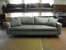 A contemporary Bolla settee upholstered in a grey fabric on chrome legs