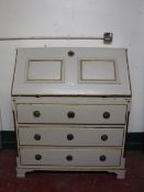 A cream and gilt painted pine writing bureau