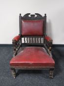 A late Victorian mahogany armchair upholstered in red vinyl
