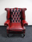 A red button leather Chesterfield armchair