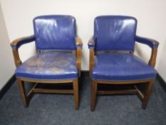 A pair of early twentieth century oak armchairs upholstered in a blue vinyl