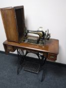 A Singer treadle sewing machine in mahogany table