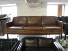 A late twentieth century Danish brown leather three seater settee CONDITION REPORT: