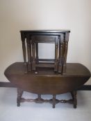 An Ercol drop leaf coffee table and a nest of three tables