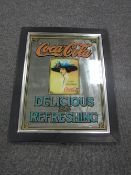 A framed reproduction Coca Cola advertising mirror
