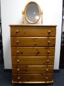 A pine six drawer chest and a vanity mirror