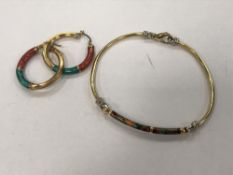 A pair of earrings and matching bangle with enamelled decoration, each stamped 750, 17.6g.