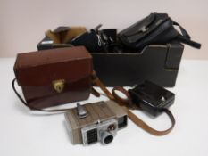 A box of vintage cameras, cine cameras,