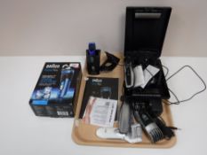 A tray containing a Braun shaver, A Remington Precision trimmer, Gillette Fusion razor with blades,
