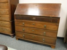 A nineteenth century oak bureau on bracket feet,