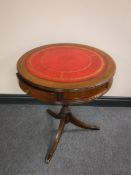 A leather topped drum table