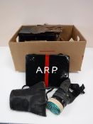 A box containing WWII items, including gas masks, eye shields, tins,