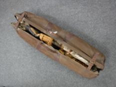 A vintage cricket bag containing vintage cricket bats, pads,