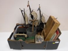 A box containing a wooden galleon, cameras, miniature cuckoo clock, music books,