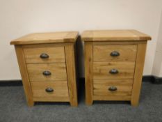 A pair of good quality light oak three drawer chests,
