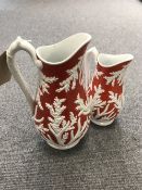 Two Victorian water jugs decoration on red ground.
