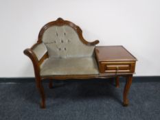 A telephone table upholstered in a green buttoned dralon