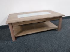 A contemporary two tier glass topped coffee table