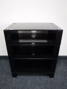 A black glass four tier audio stand
