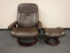 A brown leather Ekornes 'Stressless' swivel relaxer chair with footstool