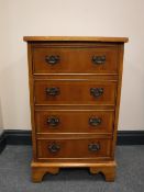 A yew wood four drawer chest on bracket feet