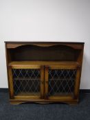 An oak leaded glass door bookcase
