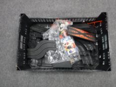 A box containing loose Scalextric track,