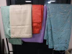 A pair of silver and turquoise lined curtains and four further pairs of various colours