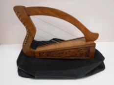 A twelve stringed Celtic harp in carry bag