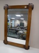 A contemporary oak overmantel mirror
