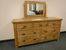 A good quality light oak seven drawer chest with dressing mirror,