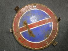 A circular enamelled road sign