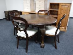 A Victorian mahogany wind out table on claw and ball feet together with four reproduction mahogany