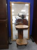 A blonde oak overmantel mirror and a two tier oak side table