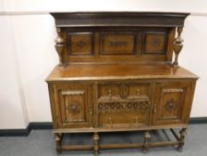 A carved Edwardian oak buffet backed sideboard
